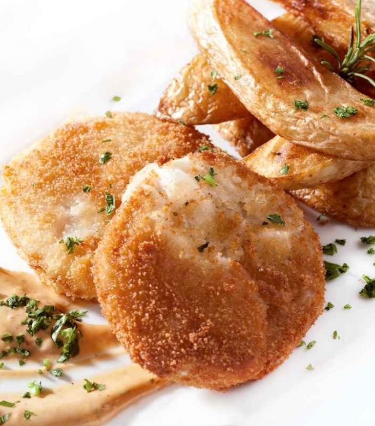 Breaded cod rolls with fried potato wedges
